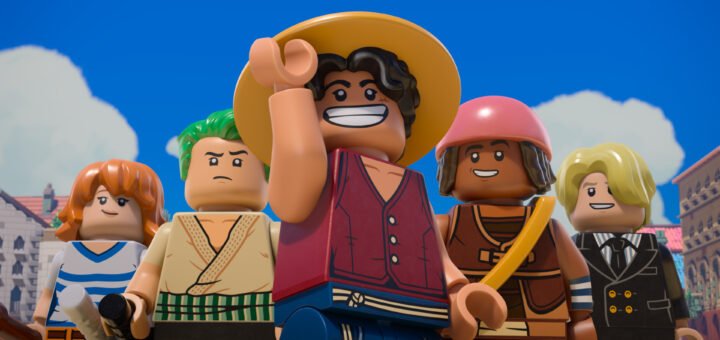 "Group of five LEGO minifigures in colorful outfits posing outdoors with blue sky and clouds, buildings in the background, central figure smiling and wearing a straw hat."